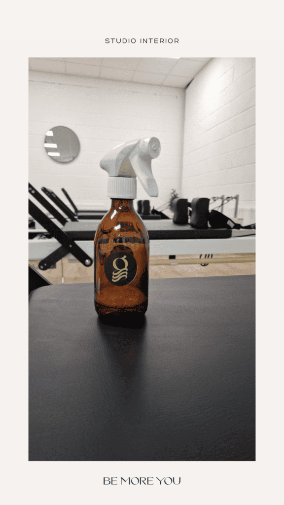 Inside the springs reformer studio with a brown glass cleaning bottle featuring the springs logo mark