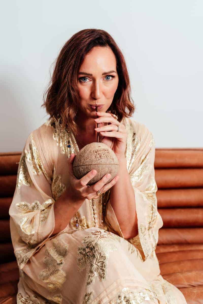 Danielle Garber Brand Designer drinking Coconut water from a genuine coconut